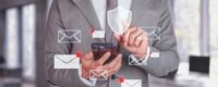 Cybersecurity and Email Protection. Businessman using smartphone with email notifications.